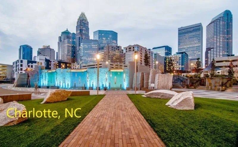 A city skyline with the words charlotte, nc in front of it.